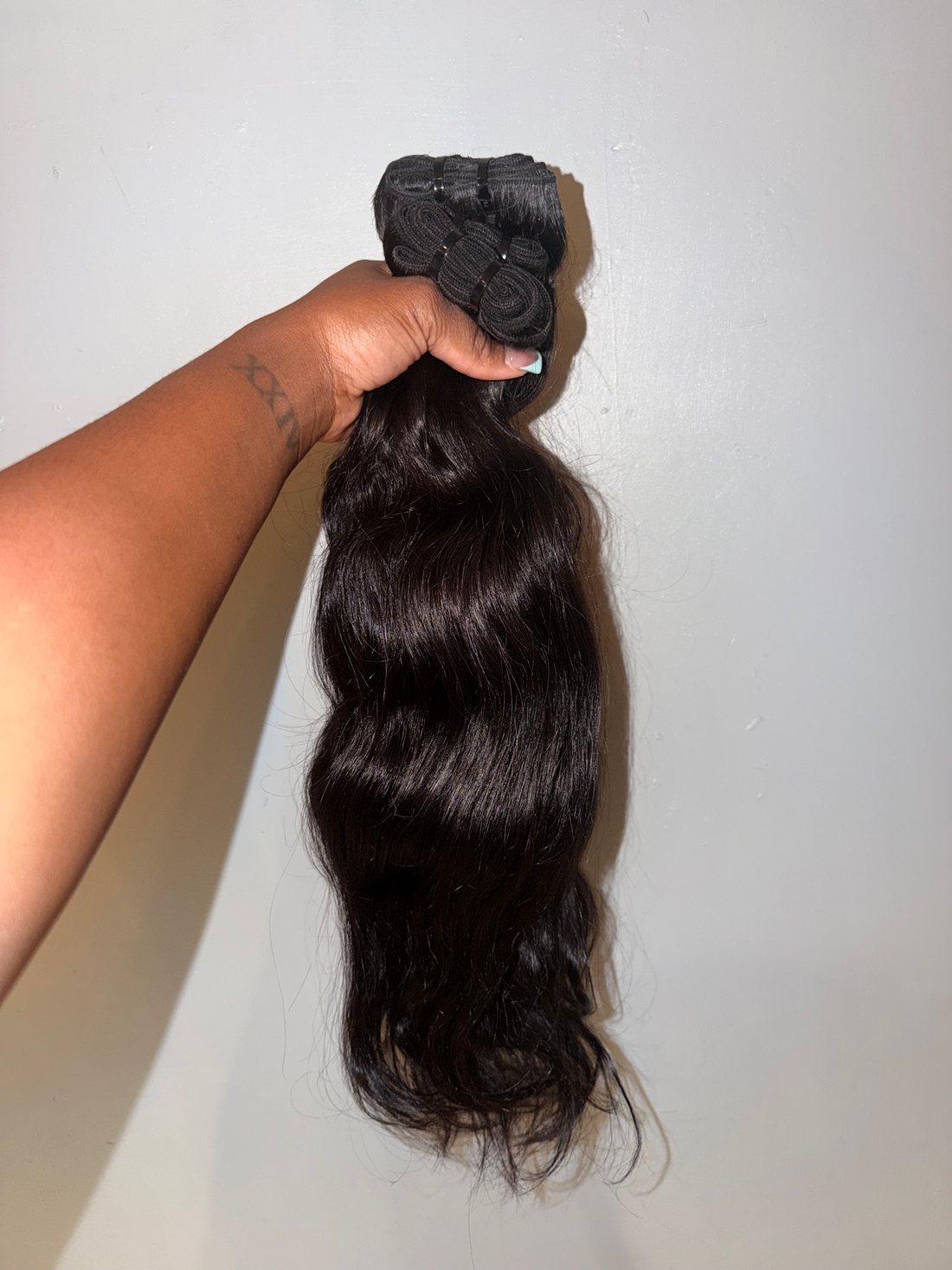 Raw Indian Temple Hair straight bundle held up, showing natural body and ends